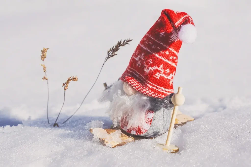 Christmas gnome decor in snow outdoors